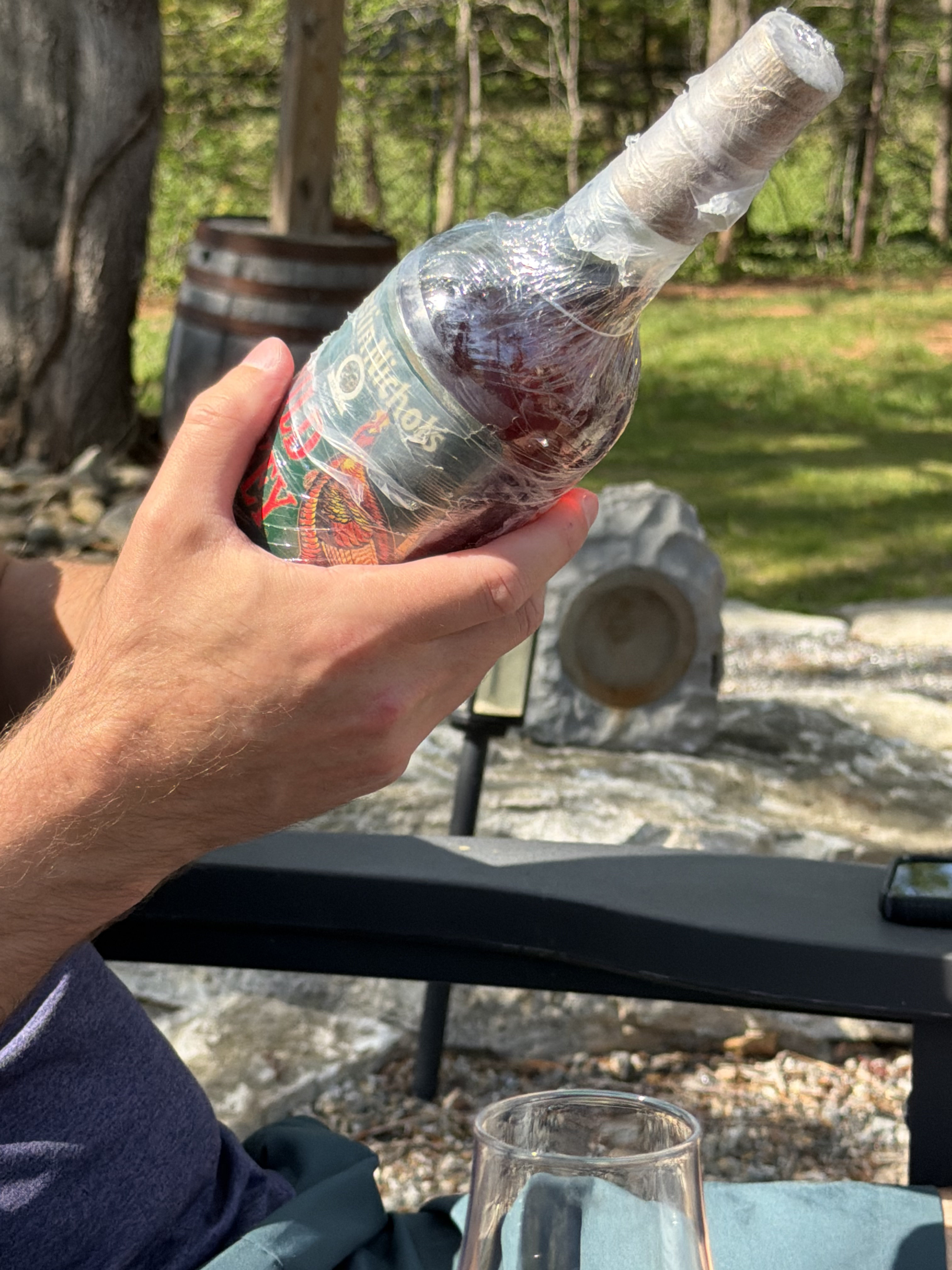 A vintage Wild Turkey bottle wrapped for protection before a pour.